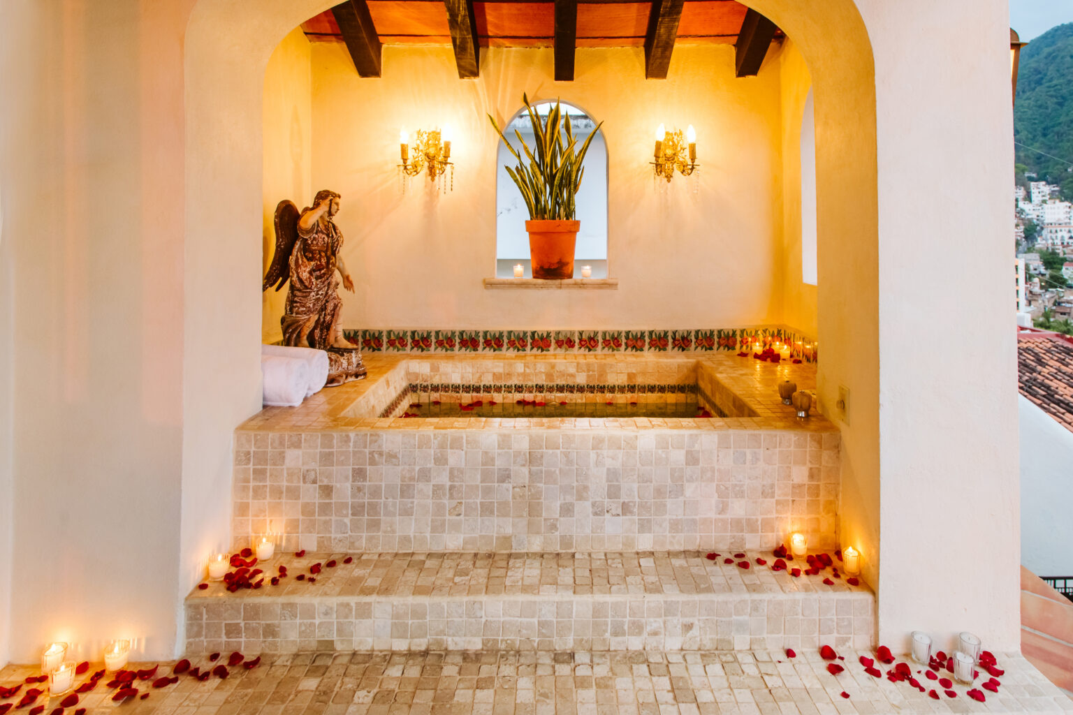 Hacienda San Angel's San Miguel Presidential Suite showcases a tiled jacuzzi on the terrace, adorned with rose petals and candles.