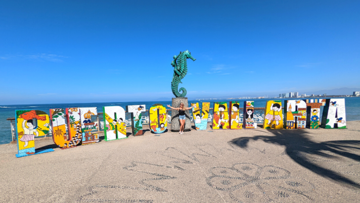 Sculpture on Malecon that spells out Puerto Vallarta in bright colors with drawings on each letter.