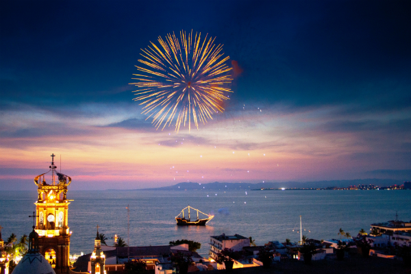 Fireworks over the Banderas Bay with Church of Guadalupe and Pirate Boat below.