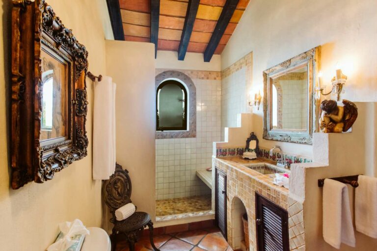 Bathroom with tile vanity and open shower.