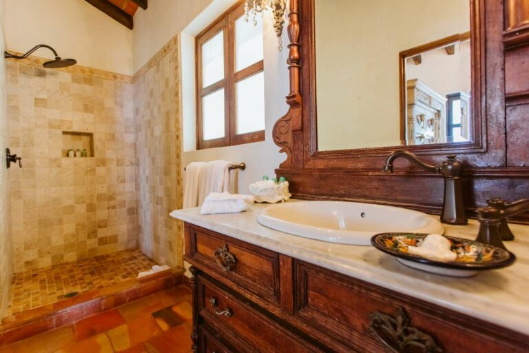 Lavatory with wooden vanity and marble sink.