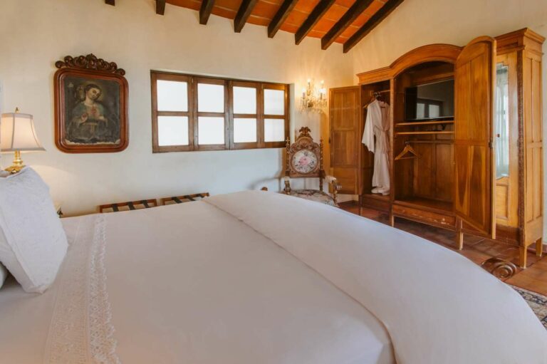 Vista de Santos Suite bed and large armoire for clothing.