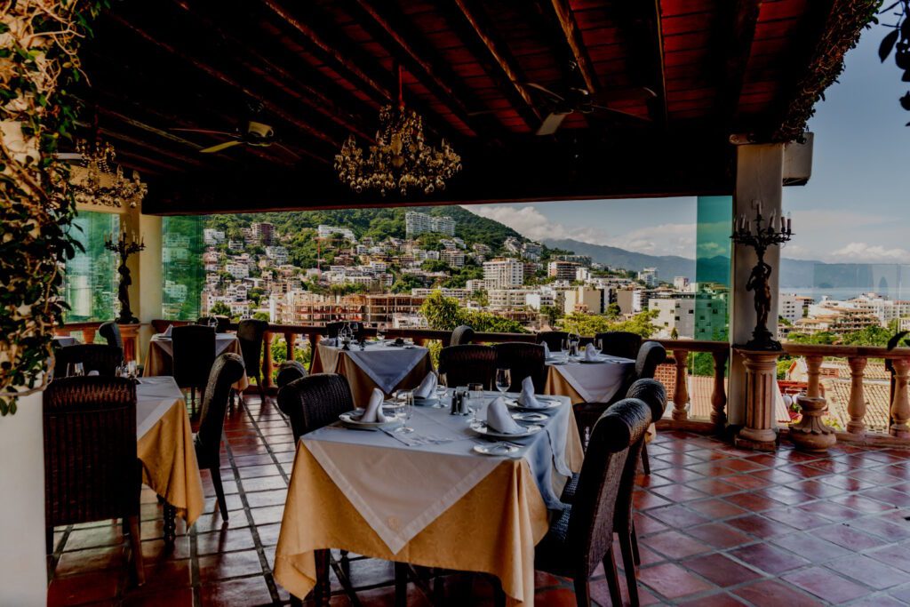 Rooftop restaurant and its breathtaking vistas of old town puerto vallarta, sierra madre mountains and banderas bay.